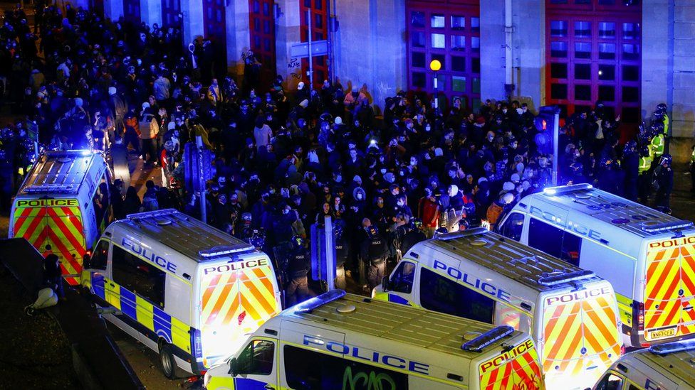 Lines of police vans and protesters in Bristol